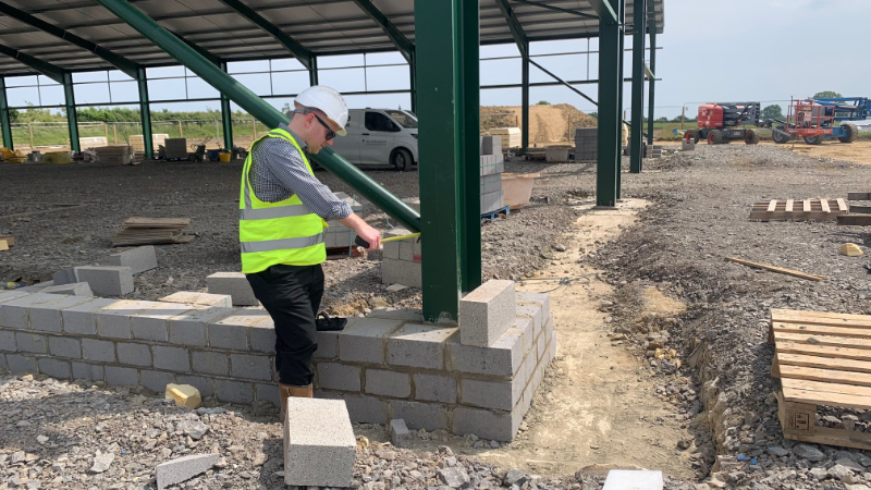 one person in high vis and hard hat looking at work complete during development